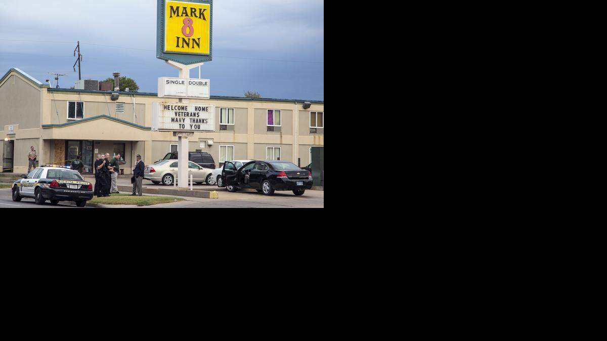 
Wichita police investigate the scene of a shooting around 10th Street between Market and Broadway on Wednesday morning after the victim made his way to the Mark 8 Inn a block away; police found him in front of the office doors. (Sept. 24, 2014)
