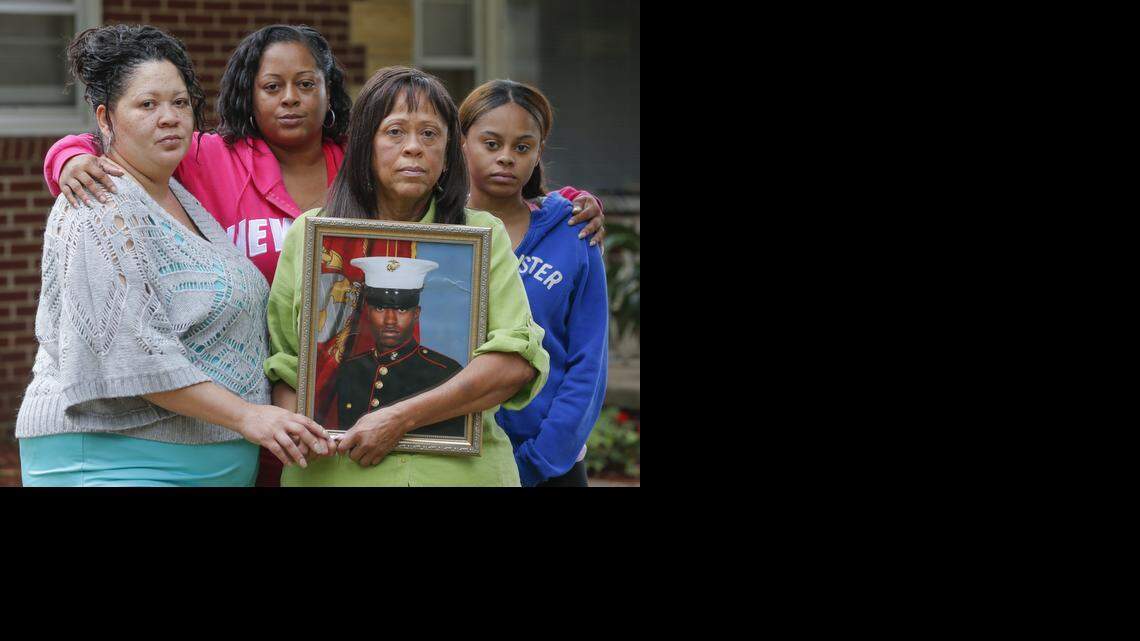 
Standing in her front yard, Beverly Allen holds a picture of her son, Icarus Randolph, while surround by her daughters Ida Allen, left, Elisa Allen and Briana Alford. All four were witnesses when Icarus Randolph was shot and killed by a Wichita police officer on July 4, 2014.
