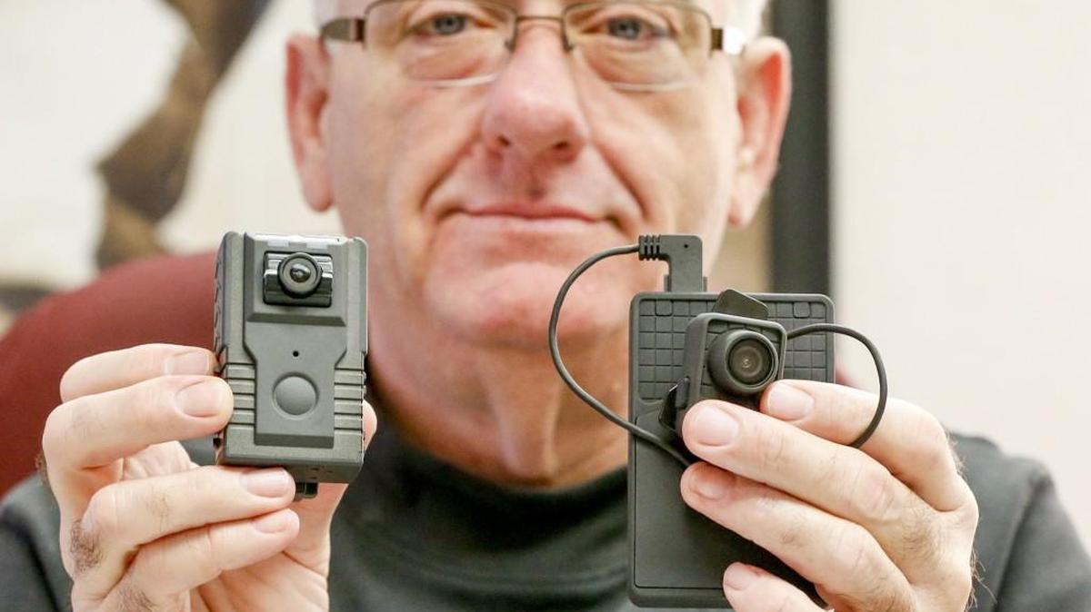 Derby Police Chief Robert Lee shows some of the body cameras his officers have used. (Dec. 22, 2015)