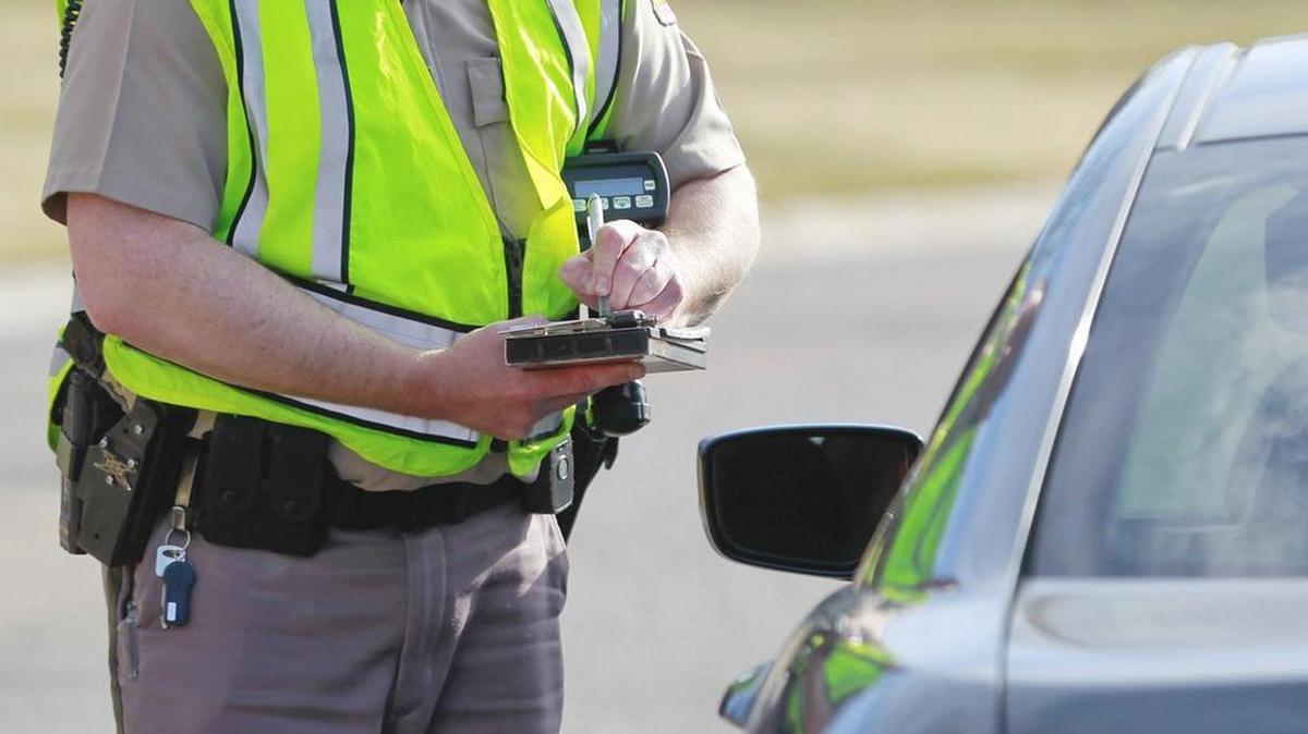 A Wichita police officer writes a ticket to a motorist near Webb and 21st street.
