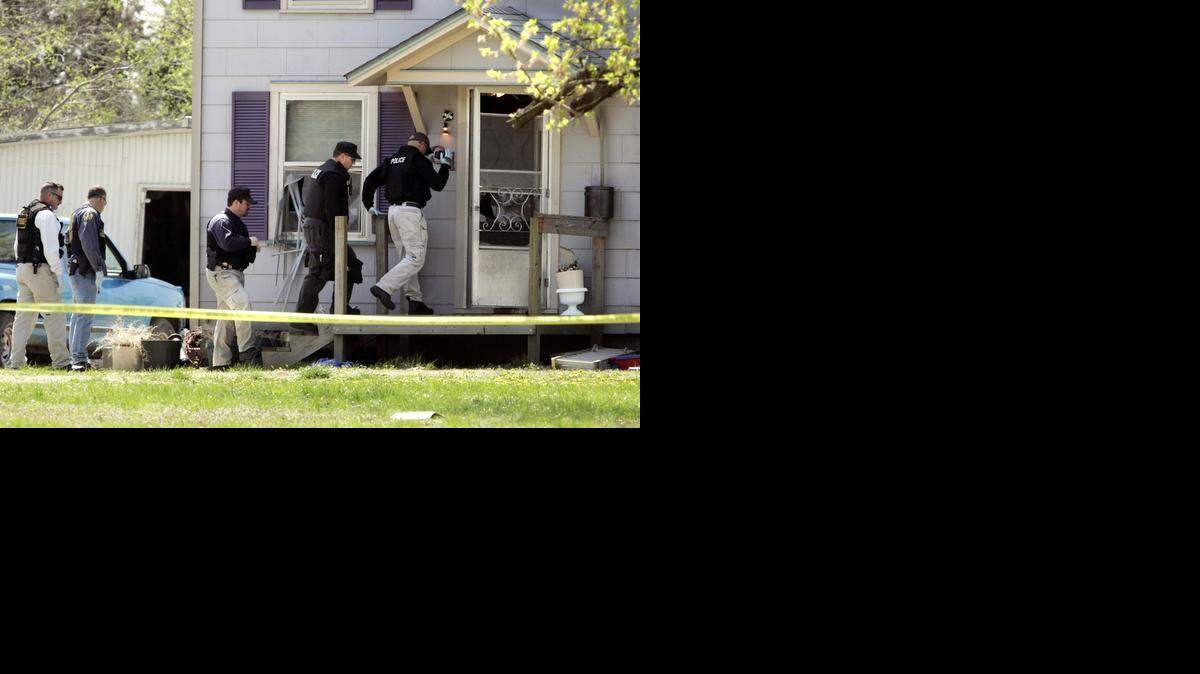 
Authorities enter the house where Harvey County sheriff's Deputy Kurt Ford was shot and killed and Hesston police Detective Chris Eilert was shot four times in 2005.
