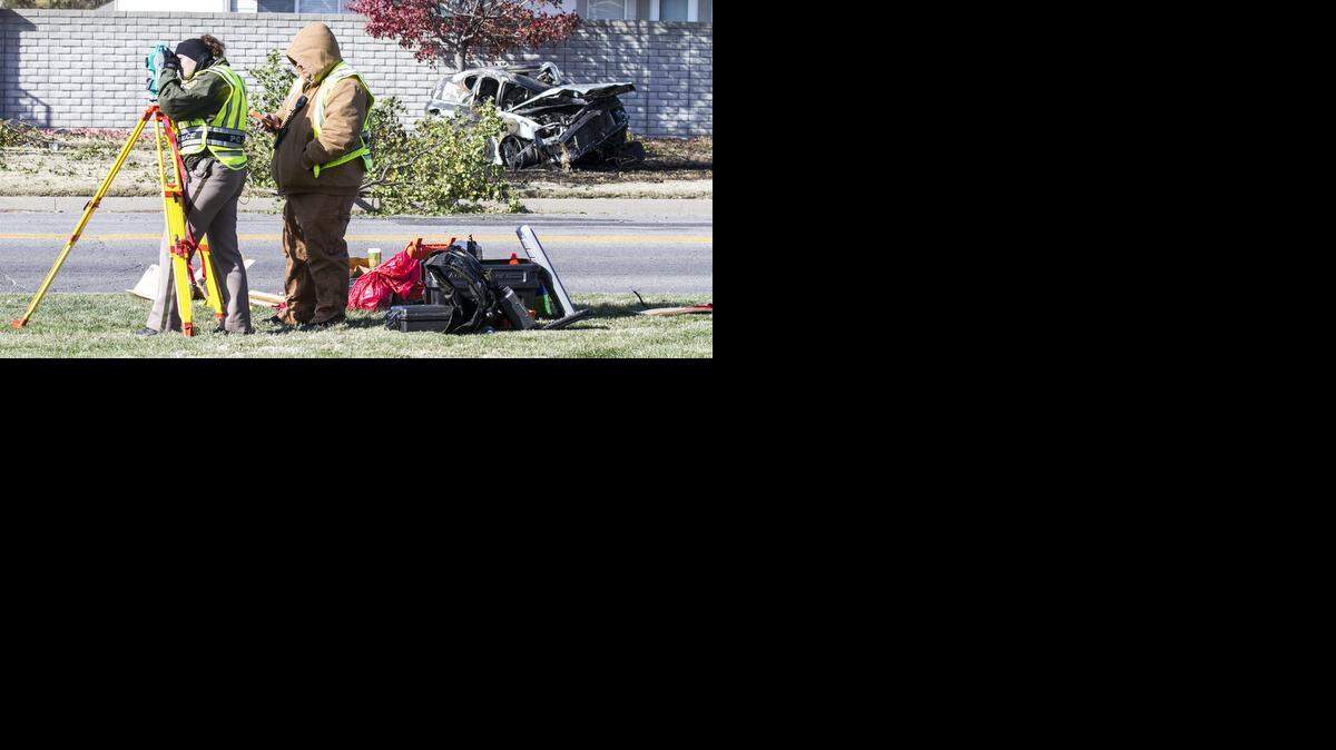 
Wichita police survey the scene of a fatal car crash Friday morning on Woodlawn north of 21st Street where one person was found dead inside a burning car. (Nov. 14, 2014)
