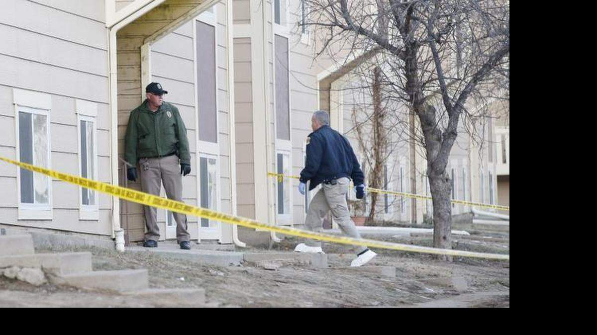 
A crime scene investigator walks around the Shores apartment complex near Pawnee and Broadway. Guarding the apartment was a Wichita police officer. Wichita police say a husband and wife were shot to death at their apartment in a double homicide. Their bodies were found shortly after midnight. (Jan. 15, 2015)
