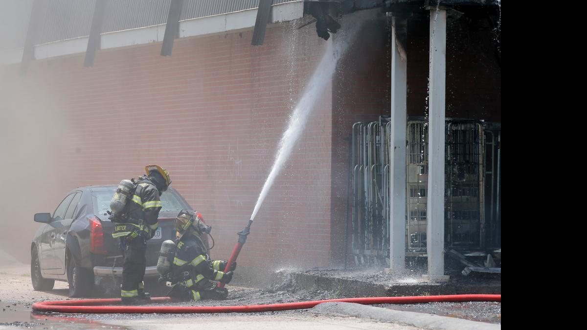 
Firefighters work a two-alarm fire at a fire at a Dollar General store near the intersection of Pawnee and Meridian on Tuesday. 

