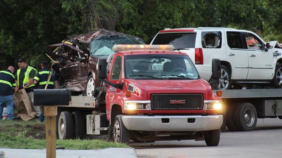 The vehicles involved in the fatal crash of a Starkey van are loaded on a flatbed truck.