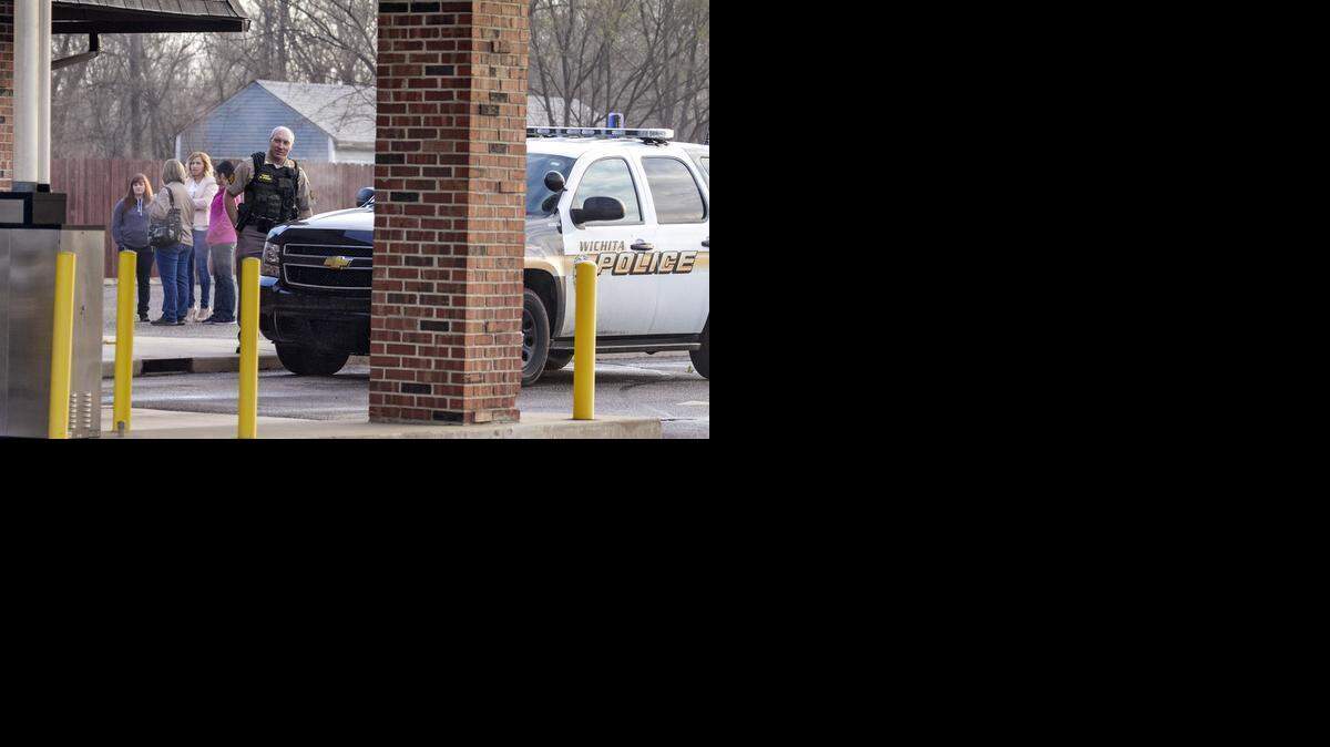 
Police investigate a robbery at Air Capital Finance on Friday morning.
