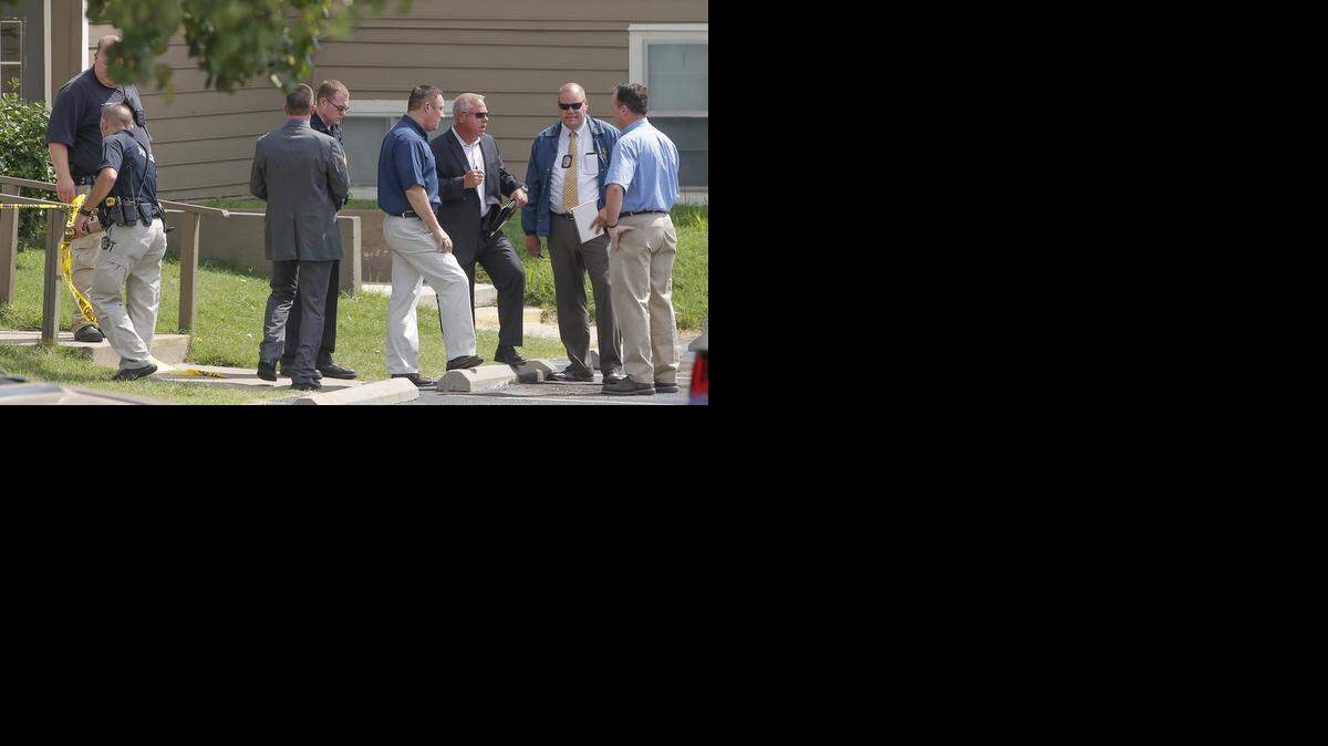 
Officers from different law enforcement agencies gather around the entrance of an apartment complex in Haysville, where an officer-involved shooting took place Tuesday morning.
