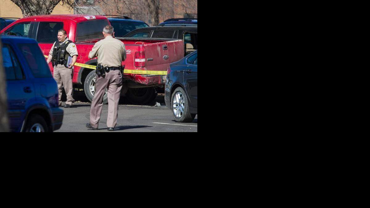 
Wichita police investigate the scene where a suspect was arrested Wednesday in connection with Tuesday’s robbery of a south Wichita bank. The suspect reportedly crashed in a Via Christi St. Francis parking lot and ran across the street to 933 N. Topeka where he was captured. (March 11, 2015) 
