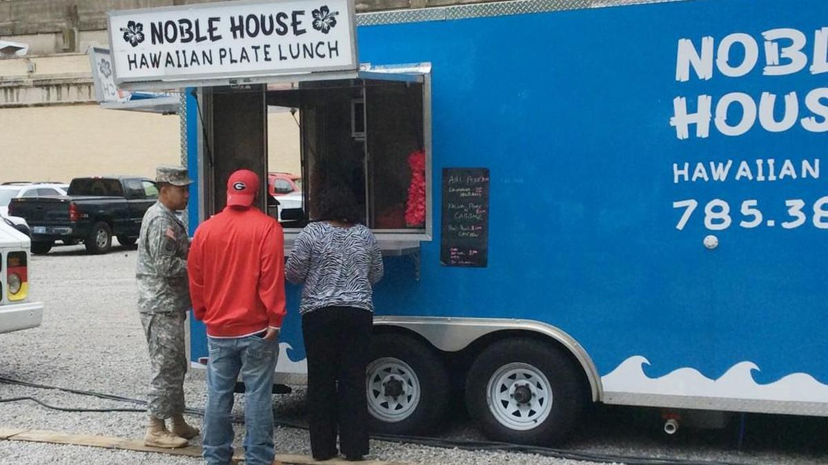 People order food at the Noble House food truck at the Pop-up Urban Park in downtown Wichita. (May 17, 2016)