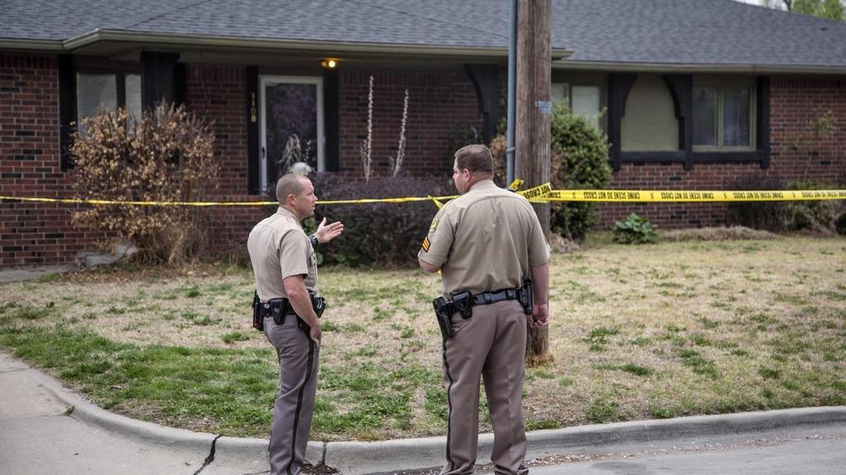 Police work the scene of a fatal shooting on April 8, 2015, in the 1100 block of West 20th Street. A jury on Thursday returned a guilty verdict against Derek Campbell in the fatal shooting of his wife, Rebecca.
