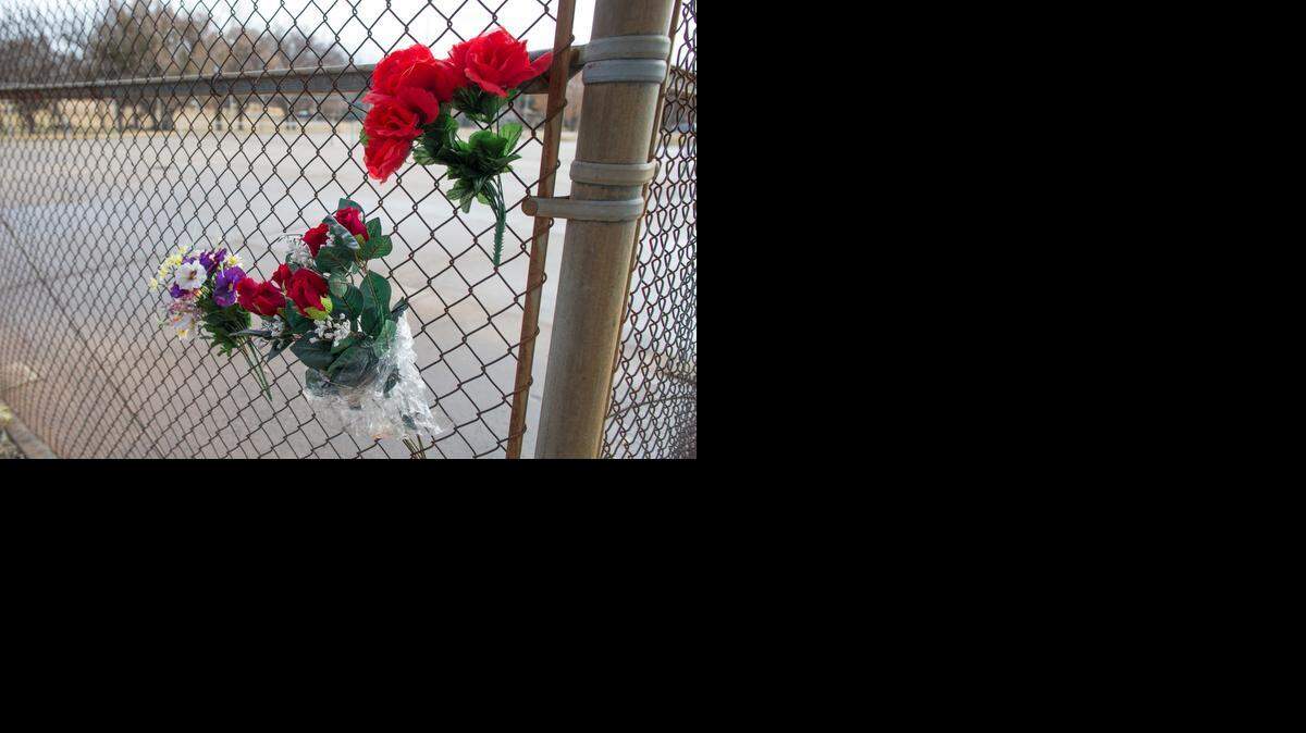 
Flowers hang on a fence near the scene at Fairmount Park where a woman was brutally attacked, raped and burned on Nov. 14. The woman died from her injuries Nov. 22.
