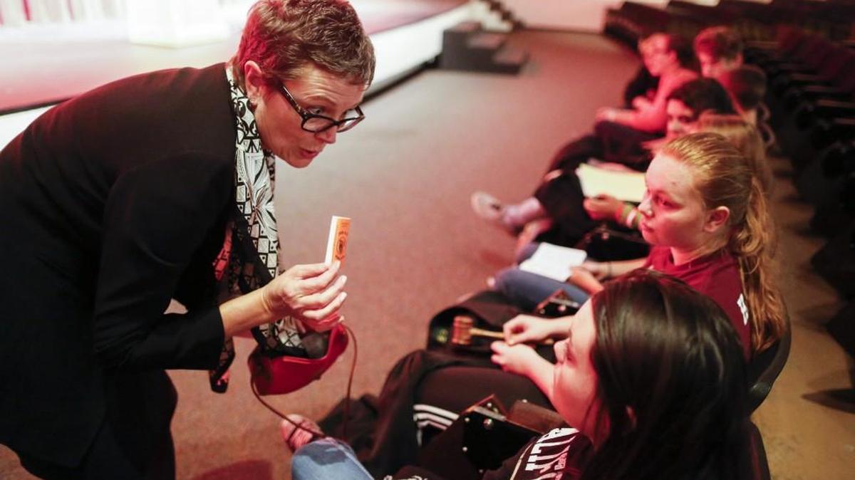 Kansas Supreme Court Justice Carol Beier hands out rolling papers Tuesday as a prop to Haven High School students who were participating in a re-enactment of a court case involving high school students’ rights in a search-and-seizure situation. (Oct. 4, 2016)