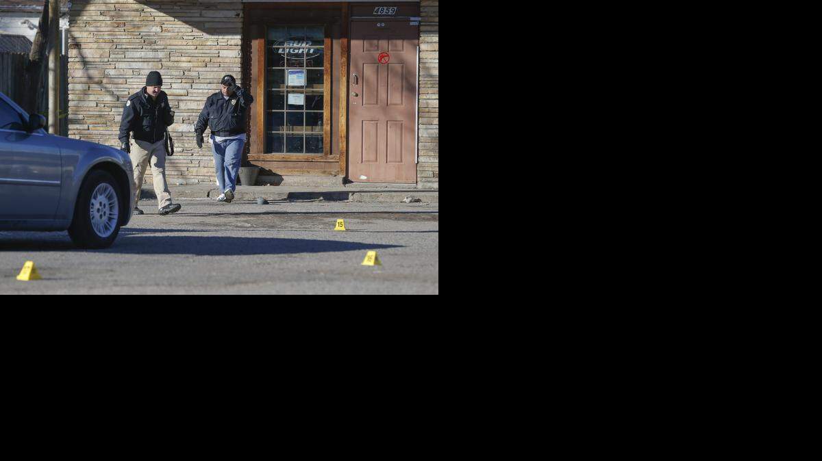 
Crime scene investigators processes a scene at the Place, 4859 E. Harry. Two people have been confirmed dead and two others wounded after a shooting over night shooting at the bar. (Jan. 10, 2015)
