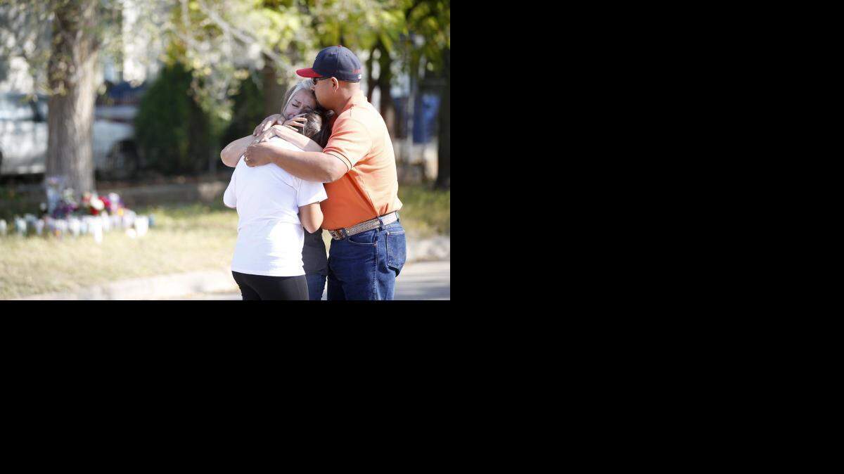 
Claudia Hernandez hugs her mother Claudia Moreno, sandwiched in the middle, and her father Omar Hernandez in front of the home where Claudia Moreno's parents were killed last week on South Ida. Two teenagers have been arrested on suspicion of murder in the deaths Martha Moreno, 70, and her husband, Godofredo Moreno, 72. (October 21, 2014)
