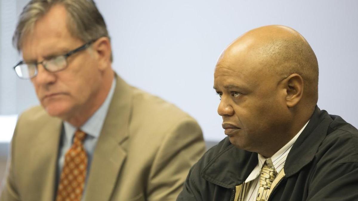 Former Wichita police officer and former Wichita public schools safety supervisor Alex Robinson sits in a Sedgwick County courtroom next to his attorney, Steve Mank, during his preliminary hearing in 2015. (April 29, 2015)