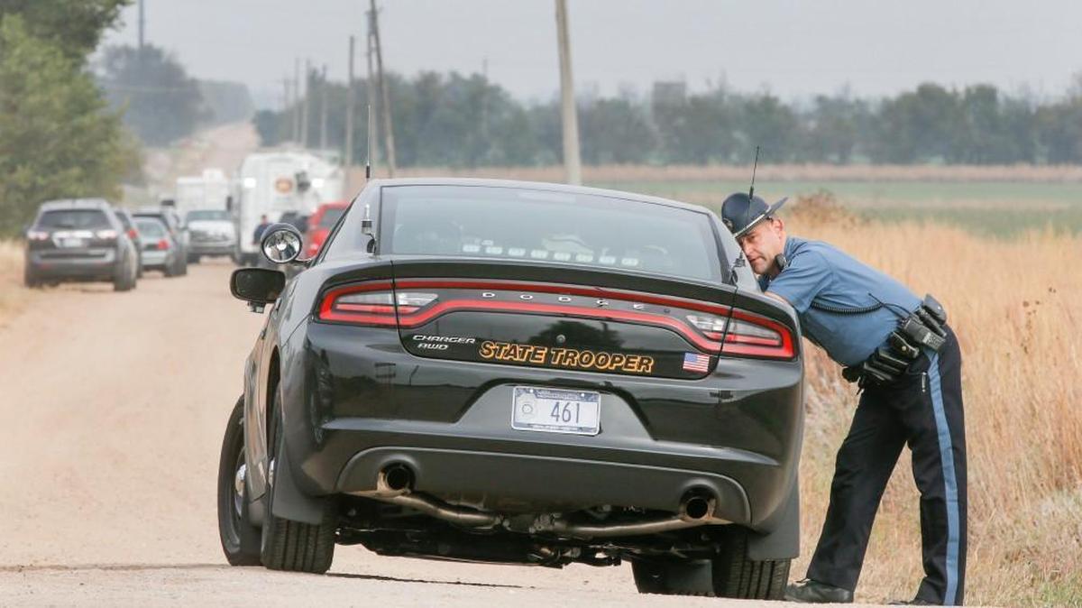 Police investigate a triple homicide on North Spring Lake Road about 5 miles west of Hesston on Monday morning. (Oct. 31, 2016)
