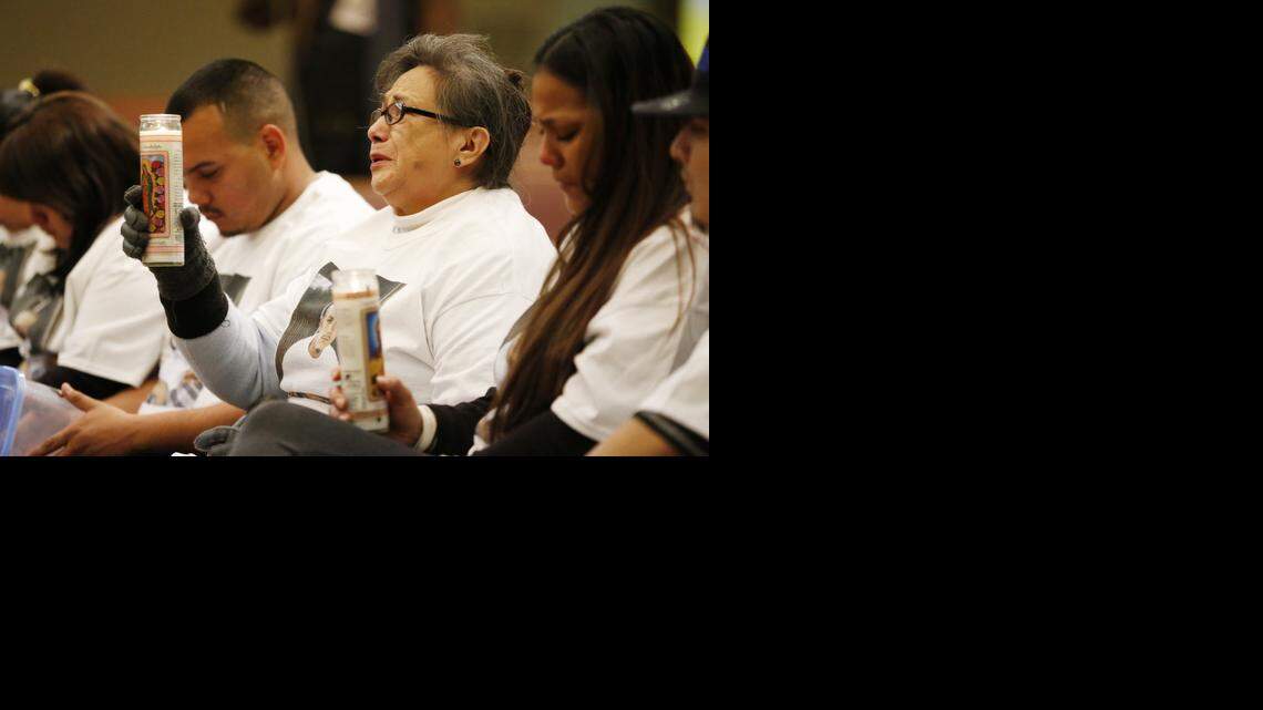 
Family members of John Paul Quintero hold candles during a vigil for the 23-year-old, who was killed Saturday by Wichita police after family members called 911 to report Quintero was armed with a knife and making threats. (Jan. 7, 2015)
