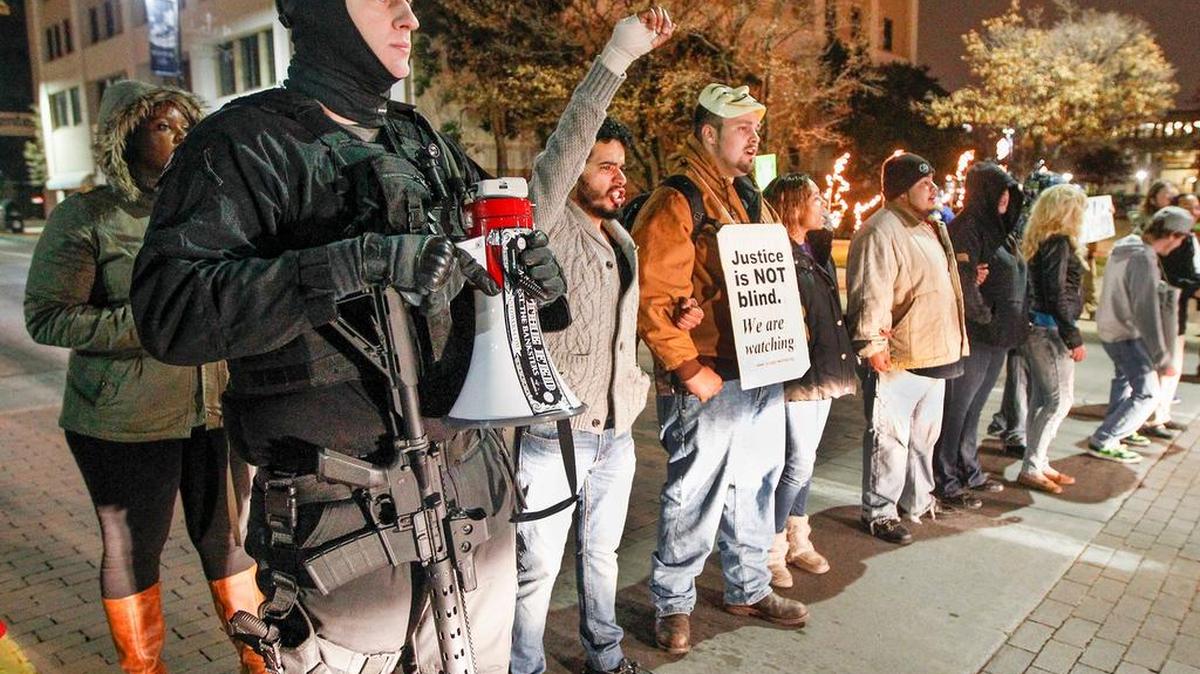 
Sam McCrory, left, protests with others against police brutality on Douglas on Dec. 11, 2014.
