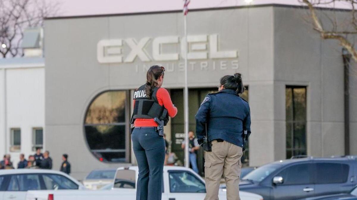 Police guard the front door of Excel Industries, where a gunman killed 3 people and injured many more, Thursday in Hesston. (Feb 25, 2016)