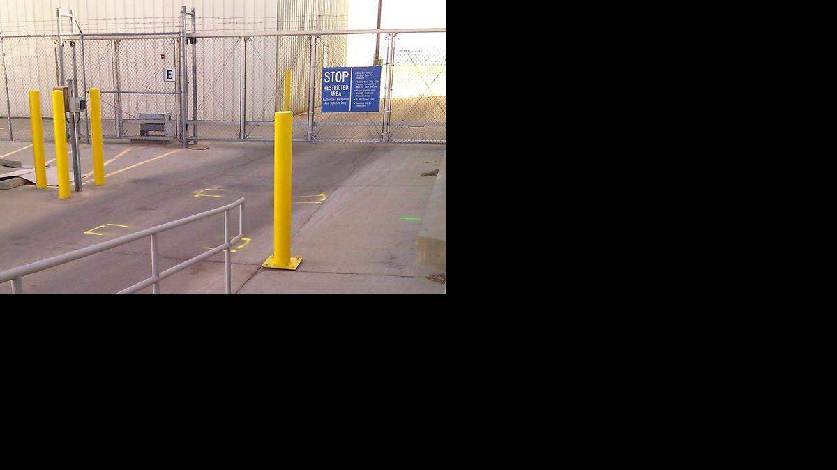 
The gate where Terry Loewen was arrested is located between Hawker Beechcraft Services, where he worked, and Yingling Aviation at Wichita Mid-Continent Airport in 2013. The yellow paint on the drive mark where the van was parked. 
