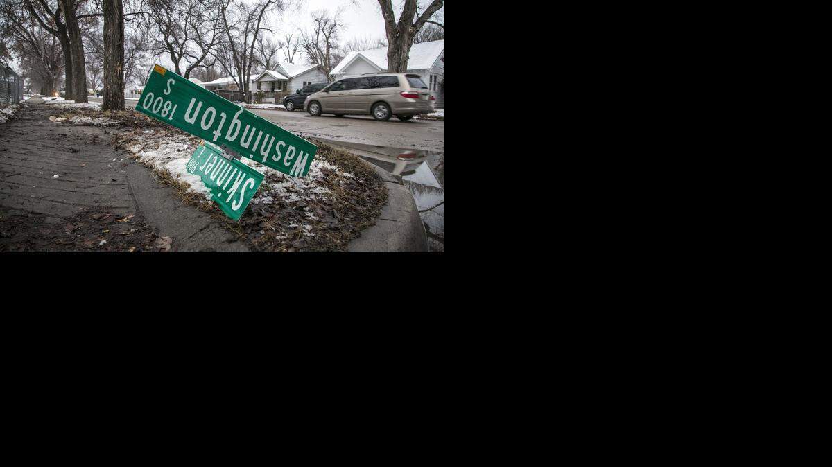 
A street sign and tree are damaged at Washington and Skinner in south Wichita after a van being chased by police jumped the curb and hit the tree.
