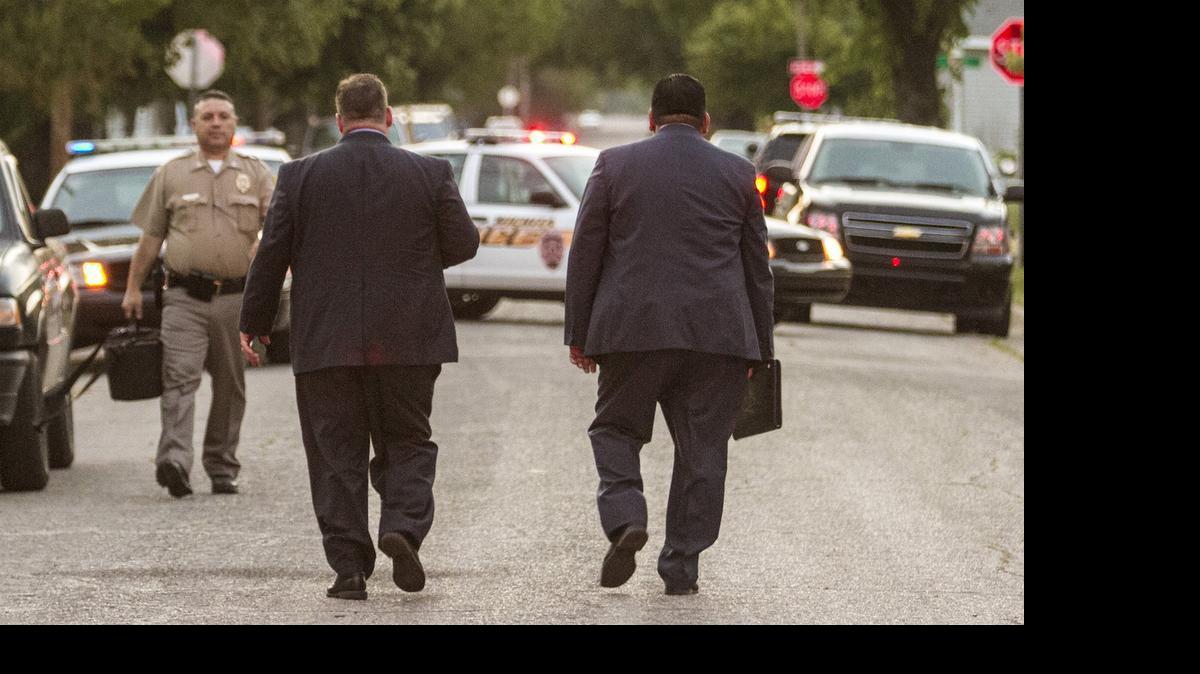 
Wichita police Capt. Doug Nolte, left, and Lt. James Espinoza at the scene of an early morning officer-involved shooting in an alley near Osie and Water in south Wichita Monday morning. (May 4, 2015) 
