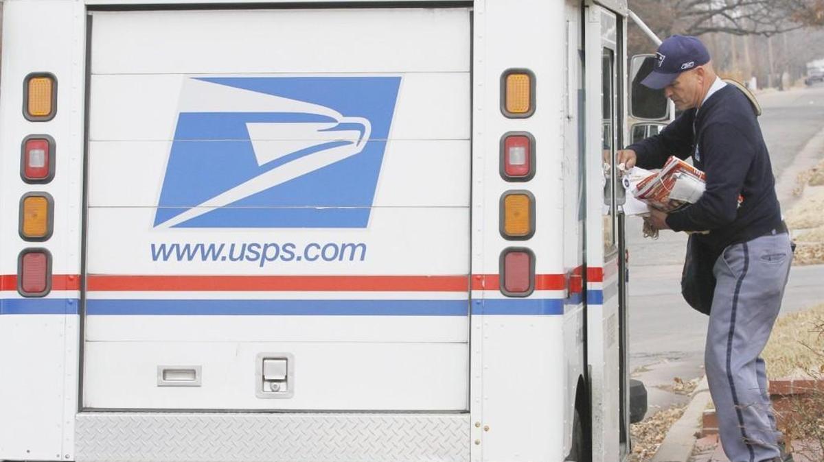 A letter carrier for the U.S. Postal Service gets ready to deliver mail in east Wichita in this file photo.