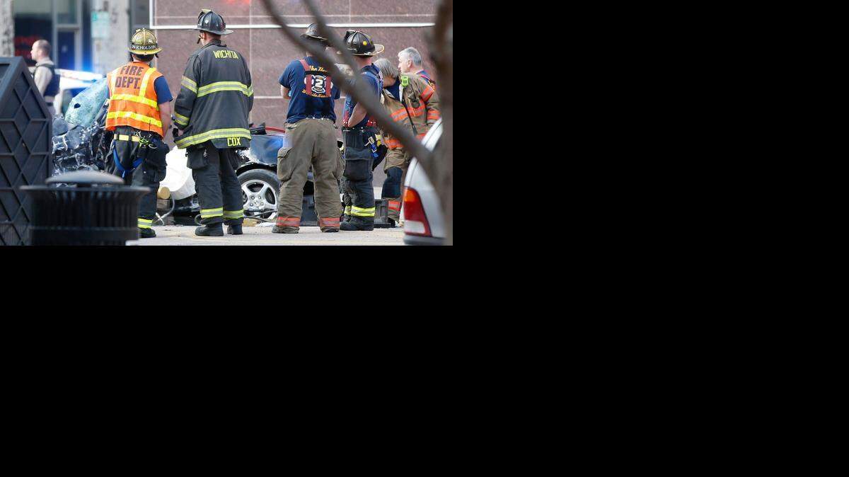 
Wichita fire and police officers investigate a fatal crash at Douglas and Market on Jan. 12, 2014.
