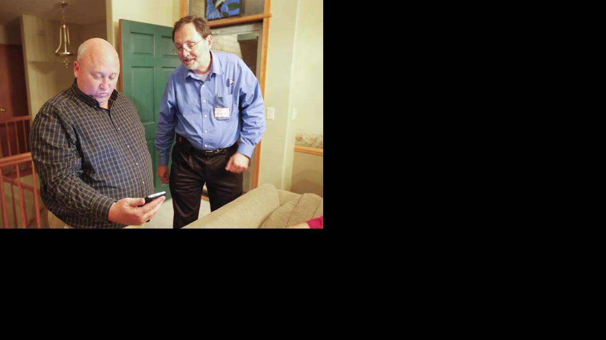 
District 4 County Commissioner Richard Ranzau looks at polling results with Karl Peterjohn on Tuesday night. Ranzau defeated challenger Carolyn McGinn.
