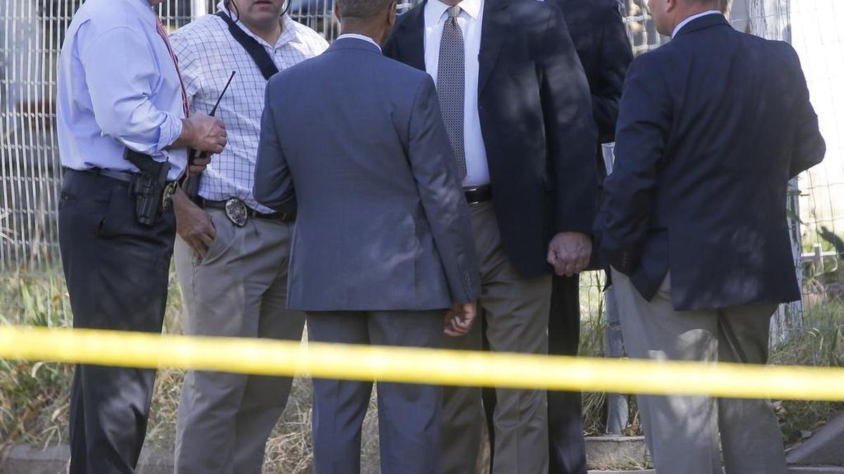 Wichita police detectives work outside of a home on South Ida where an elderly couple was found dead. (Oct. 16, 2014)