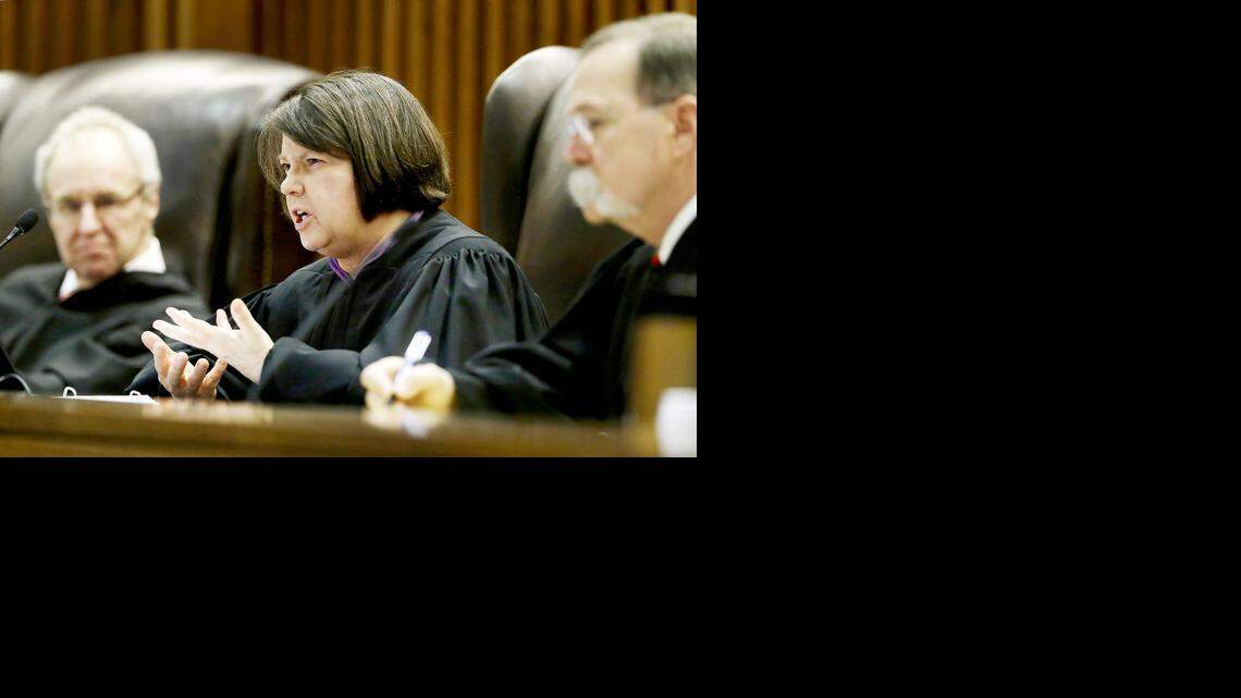 
Flanked by Justice Eric S. Rosen, left, and Chief Justice Lawton R. Nuss, right, Justice Marla J. Luckert questions an attorney for Reginald Carr during a hearing before the Kansas Supreme Court on Tuesday, Dec. 17, 2013, in Topeka. The hearing was the first of two held on separate appeals by Carr and his brother Jonathan Carr, who were sentenced to death for the shooting deaths of four people on Dec. 15, 2000, as the victims knelt on a field in Wichita, Kan. 
