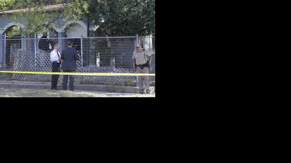 
Wichita police detectives work outside of a home on South Ida where an elderly couple was found dead in their home. (Oct. 16, 2014)
