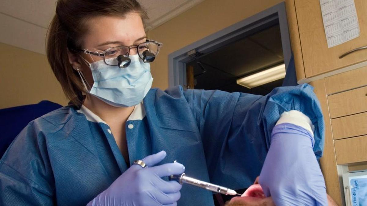 
WSU dentistry grad student Stacey Beard works with a patient at GraceMed Dental Clinic.
