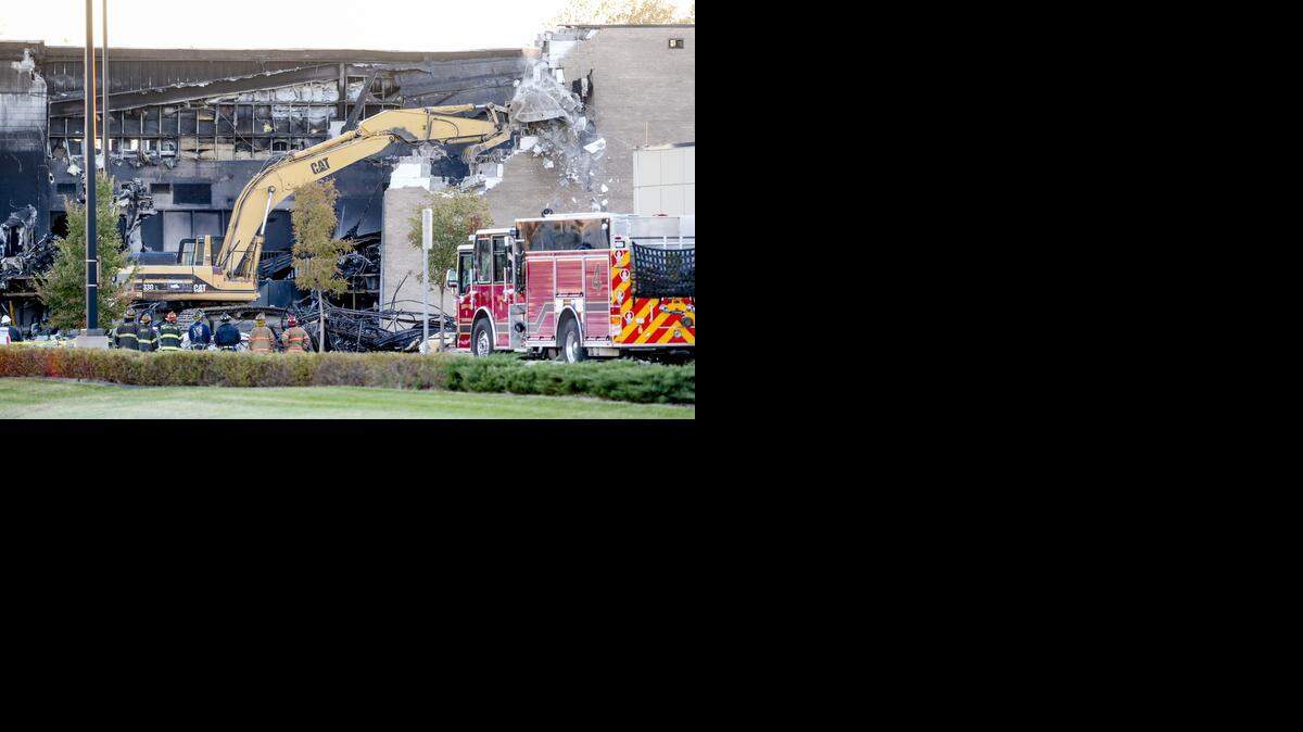 
On Friday, demolition crews knock down part of the FlightSafety building that a small airplane crashed into Thursday. Federal investigators hope to begin recovering evidence inside the building Saturday. (Oct. 31, 2014)
