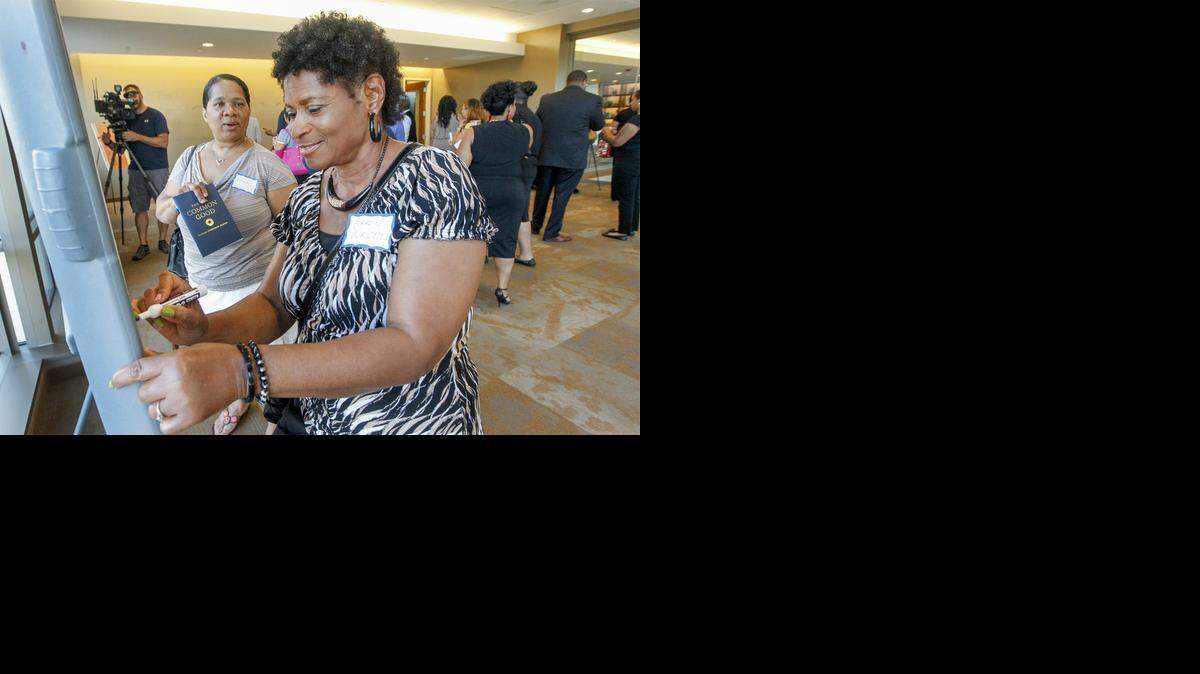 
Karen Wright writes down ideas that would make Wichita more appealing during the launch of the Wichita Urban Professionals group at the Kansas Leadership Center on Thursday. (Sept. 4, 2014)
