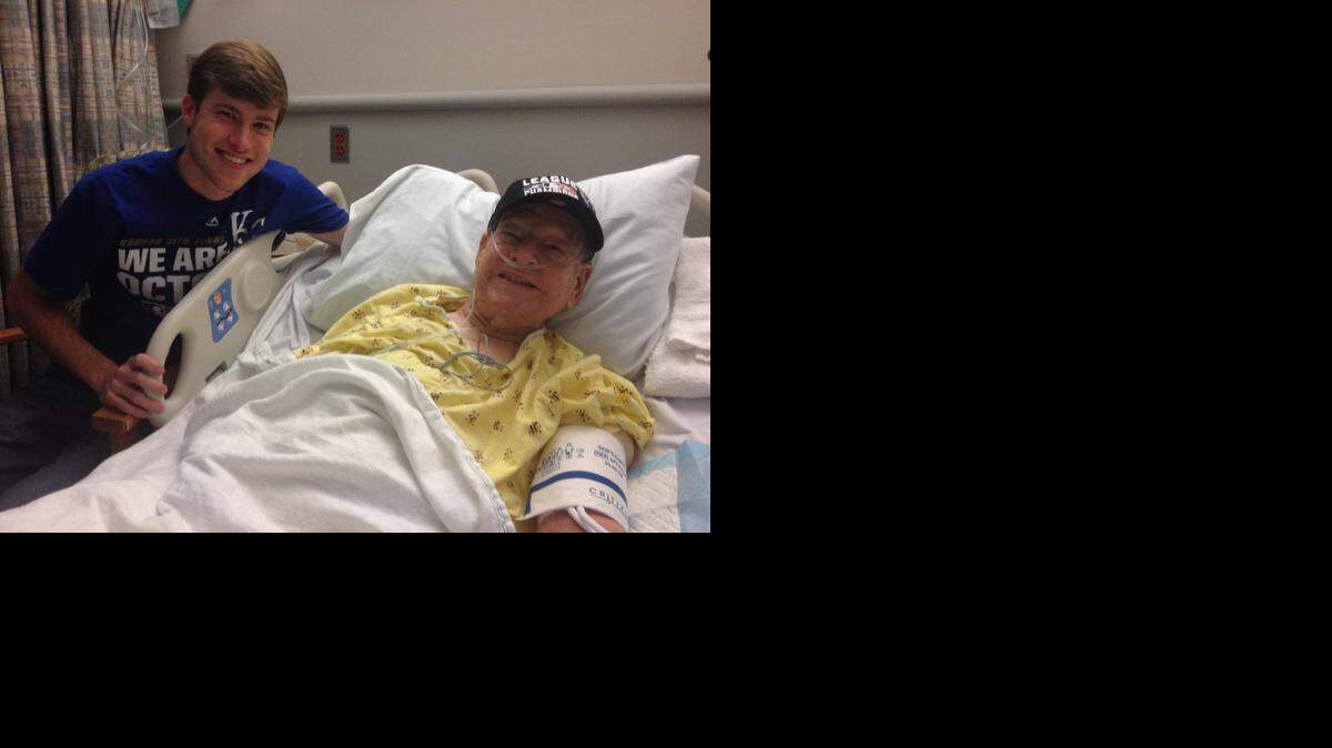 
Chris Cunningham, 17, joins his grandfather, John Cunningham, as they watch the Royals play the final World Series game Wednesday night at Via Christi St. Joseph in Wichita. On Tuesday, a photo Chris tweeted of the 88-year-old cheering from his hospital bed went viral on Twitter, prompting attention from local and national news media.
