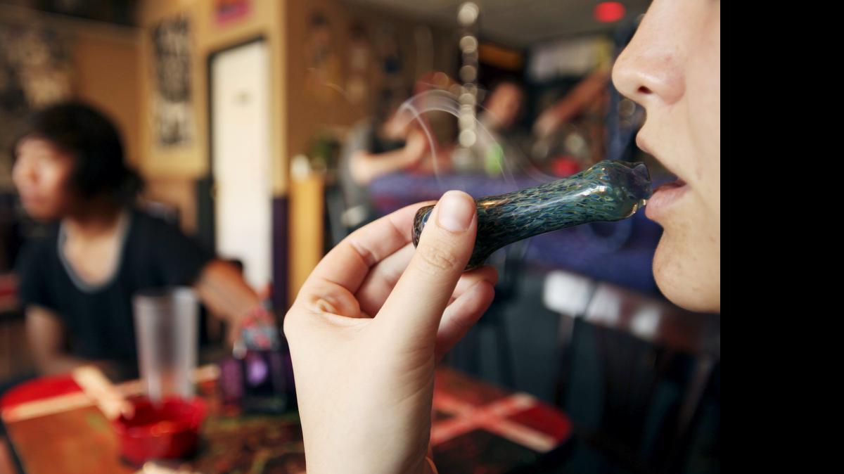 
A student from Missouri State University smokes synthetic marijuana or K2 at Petra Cafe and Hookah Bar in St. Louis. 

