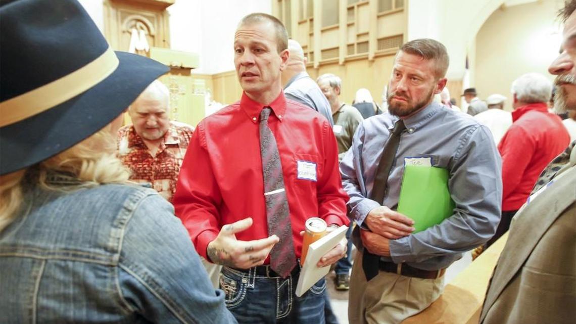Matt Griffin, left, and Joe Stuart of Oxford House talk with College Hill residents following a meeting Tuesday at the East Heights United Methodist Church. (April 19, 2016)