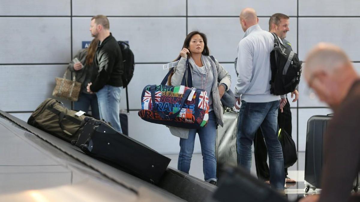 Travelers pick up their luggage Wednesday at Wichita Eisenhower National Airport. (Nov. 18, 2015)