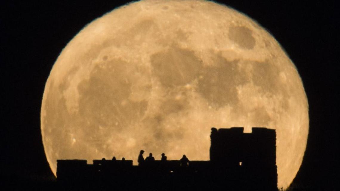 People watch the supermoon rise from atop Coronado Heights near Lindsborg on Monday night. (Nov. 14, 2016)