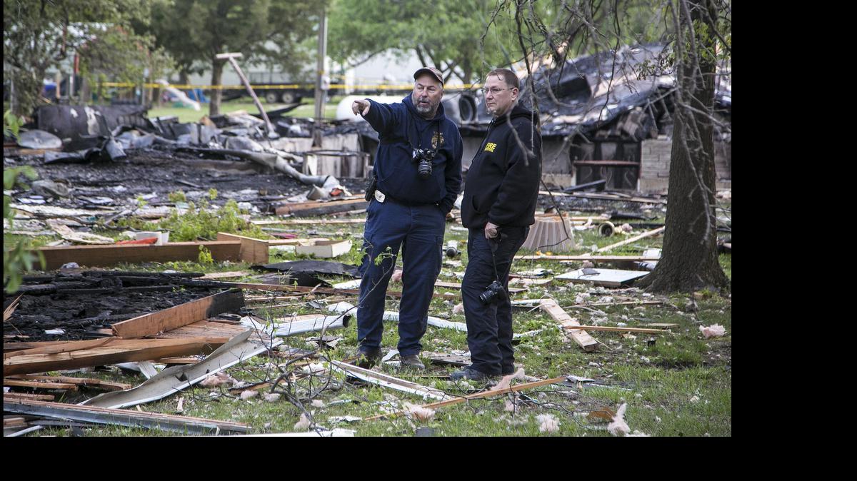 
Sedgwick County fire investigators look over the damage Tuesday morning following a fatal home explosion near Derby. Shortly before 10 p.m. Monday, neighbors reported hearing a loud explosion from a house in the 7500 block of 127th Street East. (April 28, 2015) 
