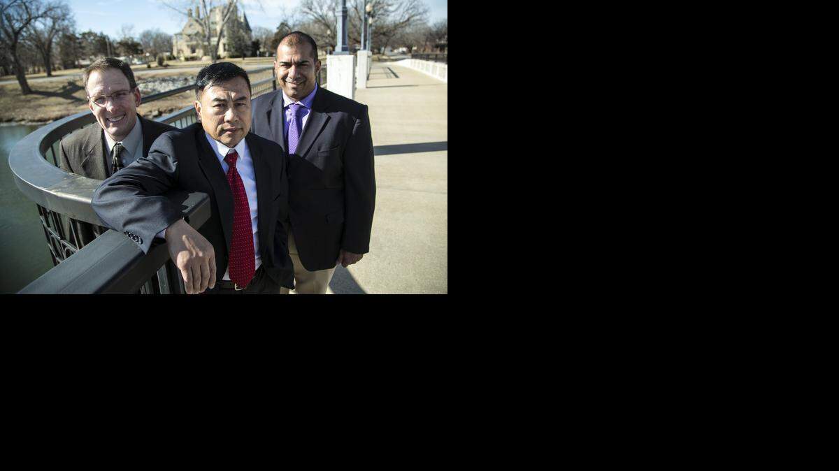 
Wichita police Lt. Clark Wiemeyer, retired, left, and Sgt. Santiago Hungria, right, received the Life Saver award for saving the life of detective Vince Van, who had a heart attack in November while the three were running. (Feb. 2, 2015)
