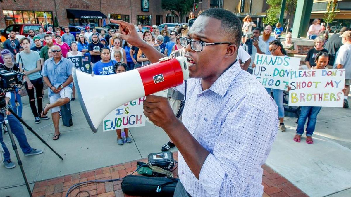 Community organizer Djuan Wash speaks to a crowd of people during a July rally in Old Town Square.