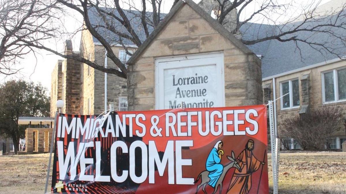A sign outside Lorraine Avenue Mennonite Church in Wichita welcomes immigrants and refugees while depicting Mary, Joseph and Jesus as refugees fleeing to Egypt.