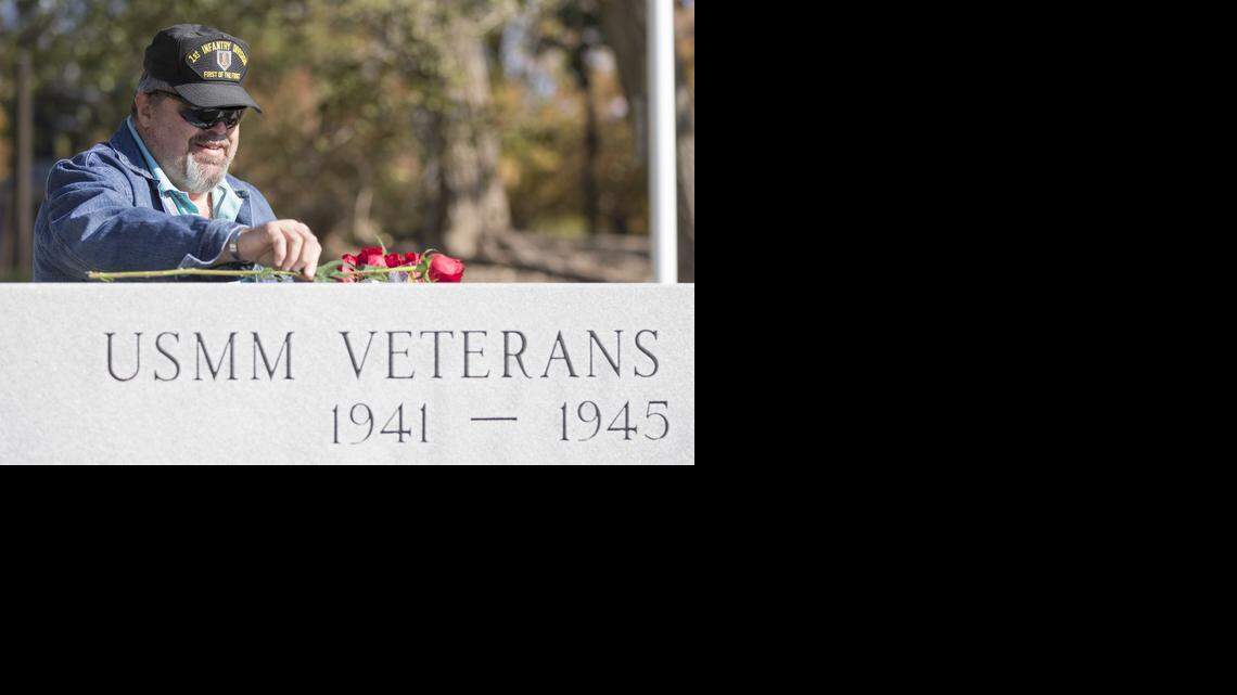 
Army veteran Mike Fitzgerald places a rose at a Merchant Marine memorial at Veterans Memorial Park on Tuesday. Fitzgerald placed a rose and offered a salute at every memorial at the park for Veterans Day. (Nov. 11, 2014)
