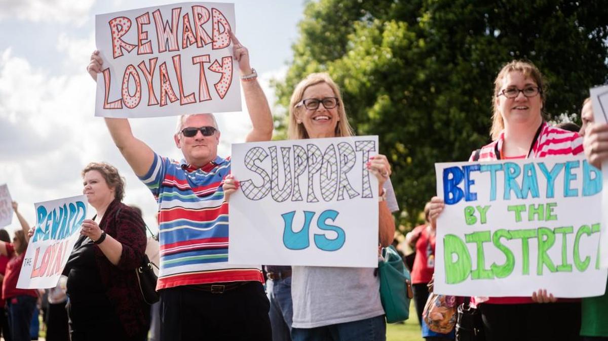 From left, Susan Osborne, a seventh-grade science teacher at Mead Middle School; Scott Pittman, seventh-grade language arts teacher at Jardine Middle School; and Kari Herpolsheimer, a sixth-grade science and math teacher at Jardine, rally in support of educators Monday evening outside North High School. (April 25, 2016)