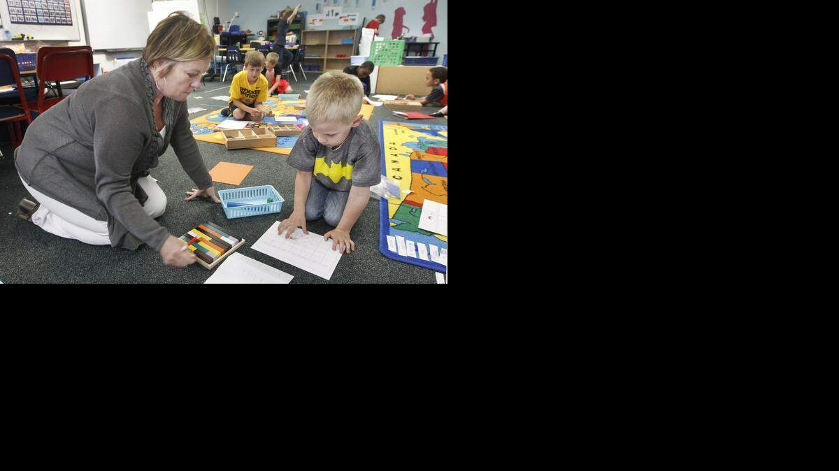 
Right Literacy Academy teacher Billie Vliet, left, works with 6-year-old Tommy Barbour on a project at the school Friday. (April 10, 2015)
