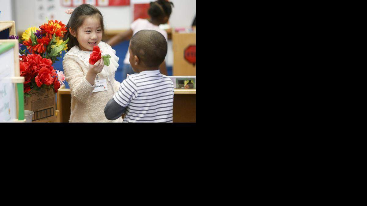 
Students at the Little Early Childhood Center in northeast Wichita play with flowers. (Feb. 5, 2015) 

