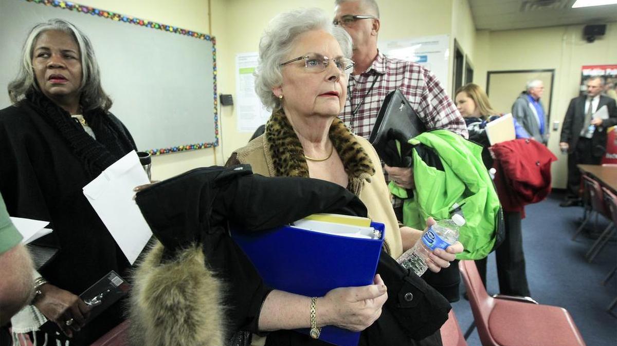 Wichita school board president Sheril Logan, center, and other school board members leave a special meeting Thursday that started discussions on finding a new superintendent. (Jan. 5, 2017)
