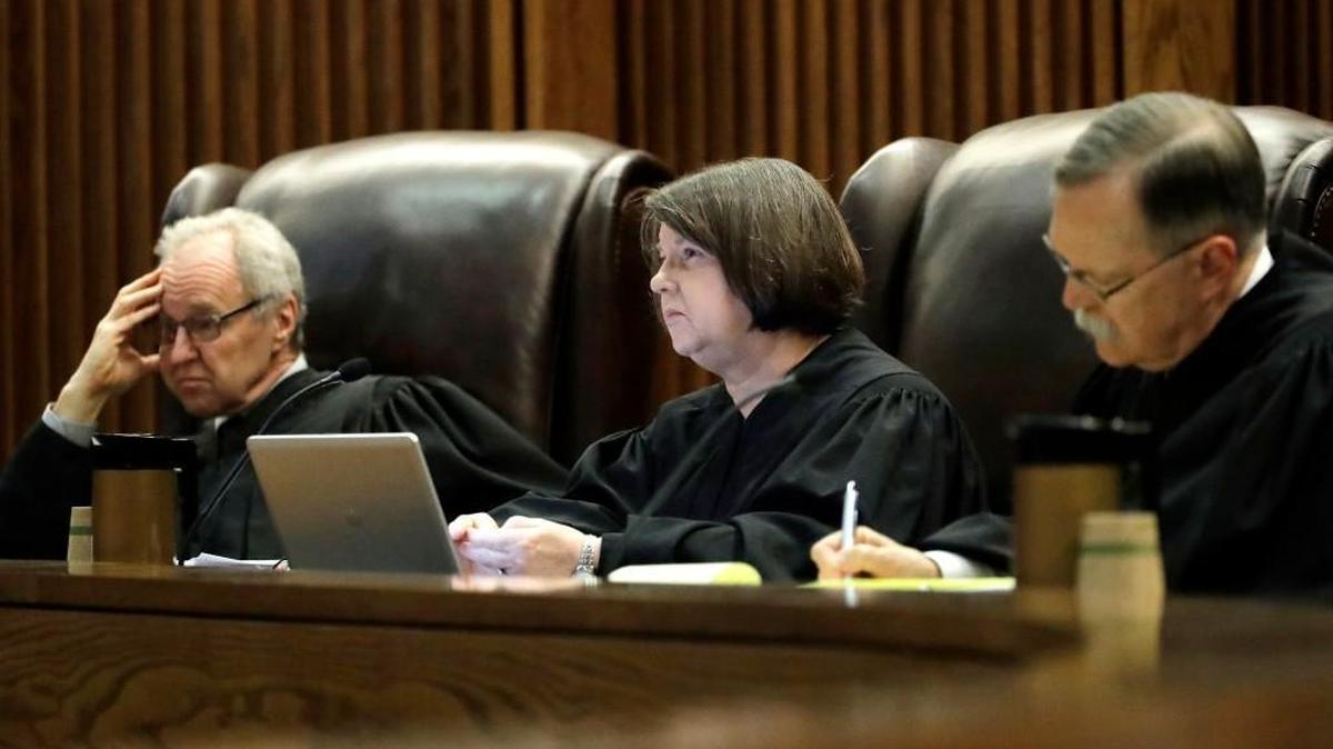 Justices Eric Rosen, left, Marla Luckert, center and Lawton Nuss listen to arguments in the school funding case in the Kansas Supreme Court on Sept. 21, 2016, in Topeka.